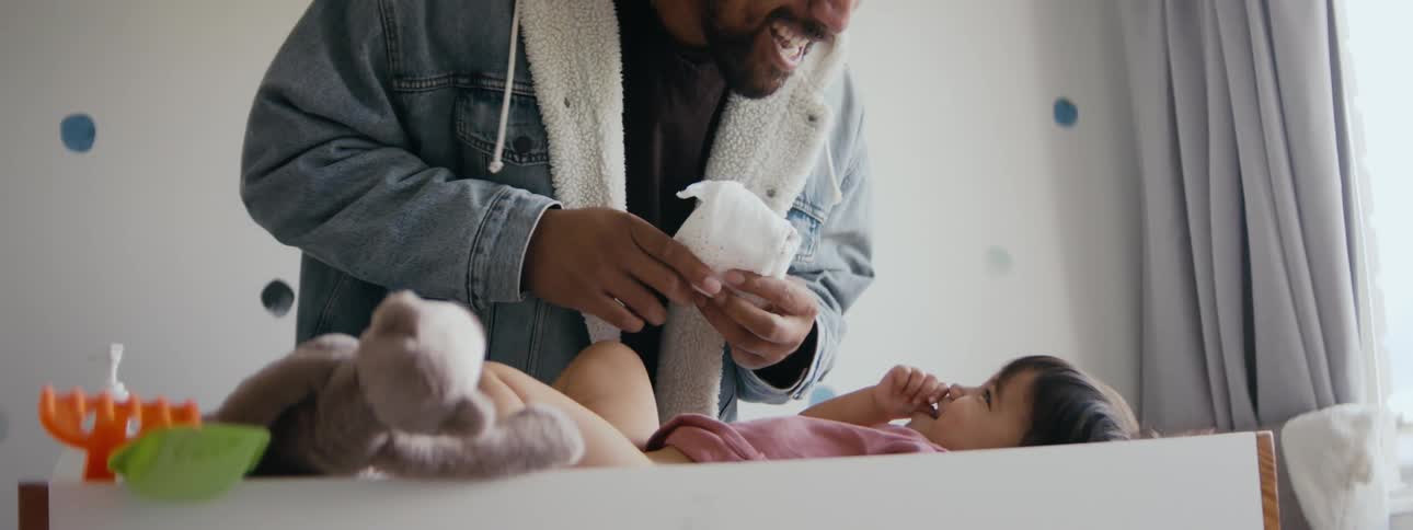 A young father is goofing around with his daughter