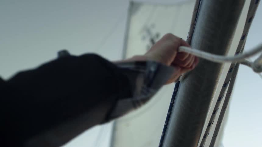 A man ties rope on a boat