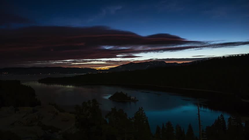 Clouds move over the lake as the sun rises