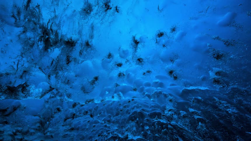 Ice snow and rock tinged with a blue light