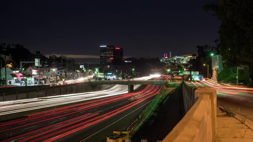 Heavy traffic passes by a city at night