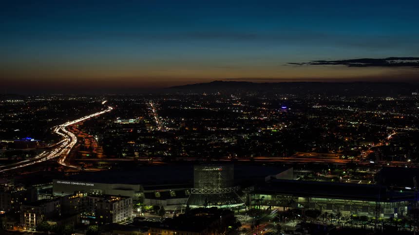 Traffic passes by a stadium in the heart of a city