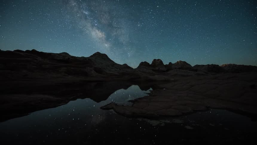A view of the milky way over some mountains