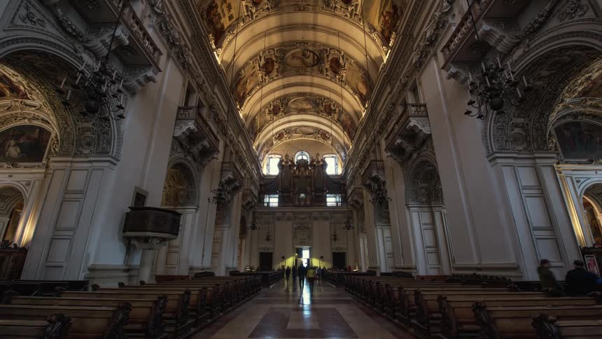 People are walking through a very old and large church