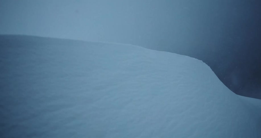 A large snowdrift rises up in the night