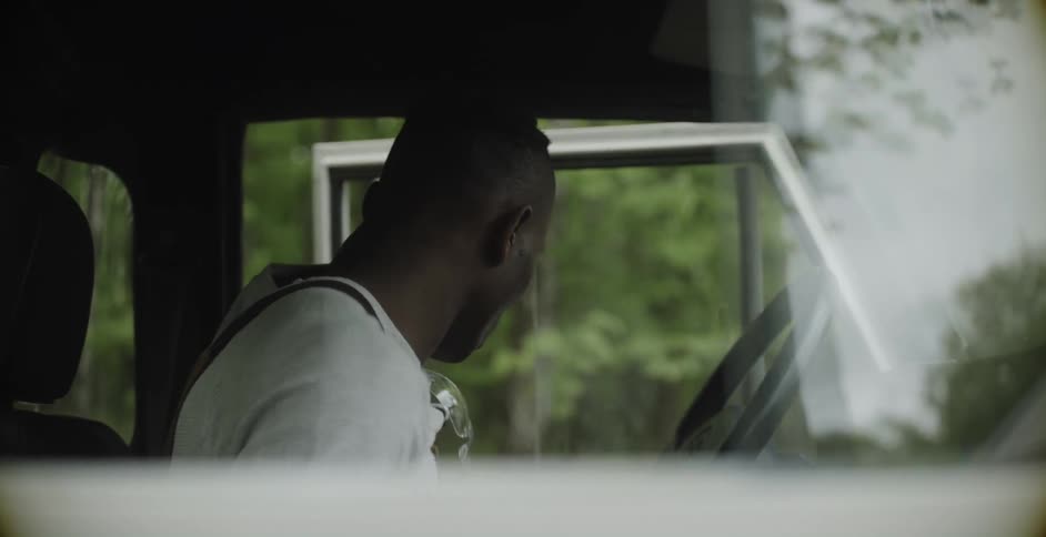 A man parks the vehicle then gets out through the door