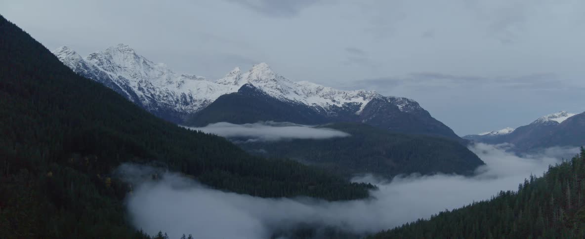 A view of a mountain range with snow on it