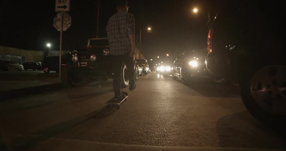 A person skateboards down a crowded road