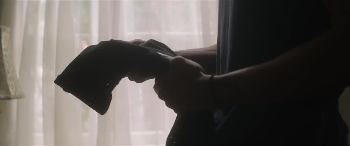A man grips a piece of clothing in his hands