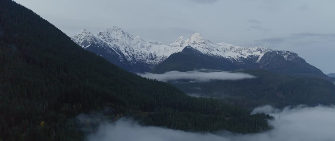 Low clouds near snow capped peaks