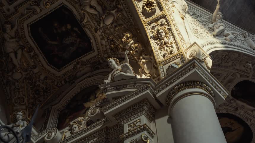 The sunlight moves across the angel sculptures and painting and murals above ornate and gilded columns