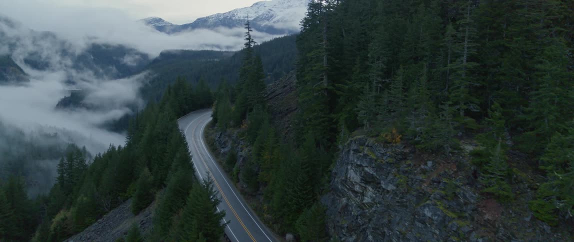 A mountain road to snow covered peaks