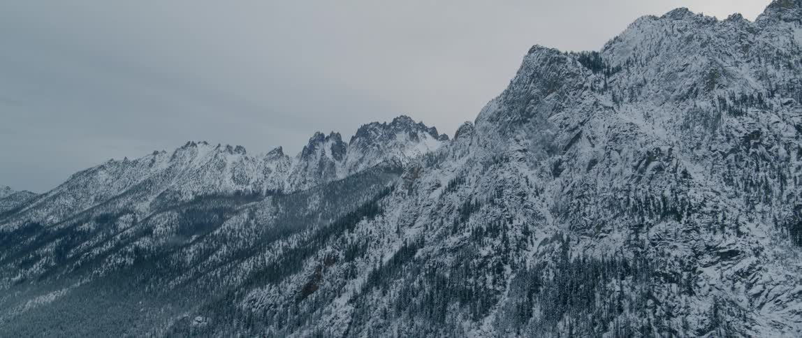 An aerial view of mountains with snow