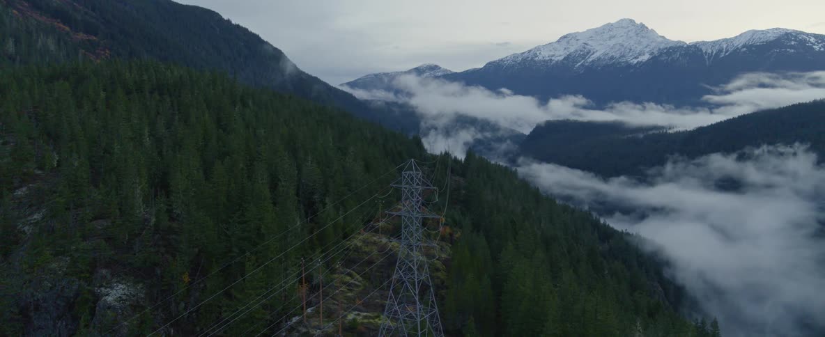 Aerial over a cell tower in a forest mountain scape