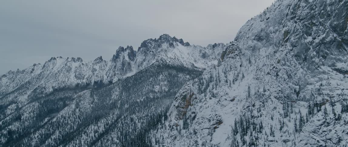 An aerial view of a mountain covered in snow