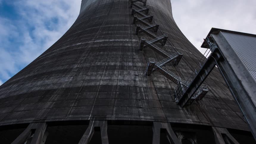 Time lapse of clouds moving over nuclear power cooling tower