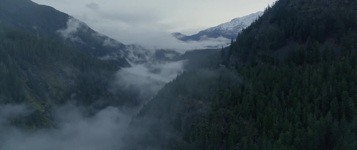 Dense fog settles between mountain peaks