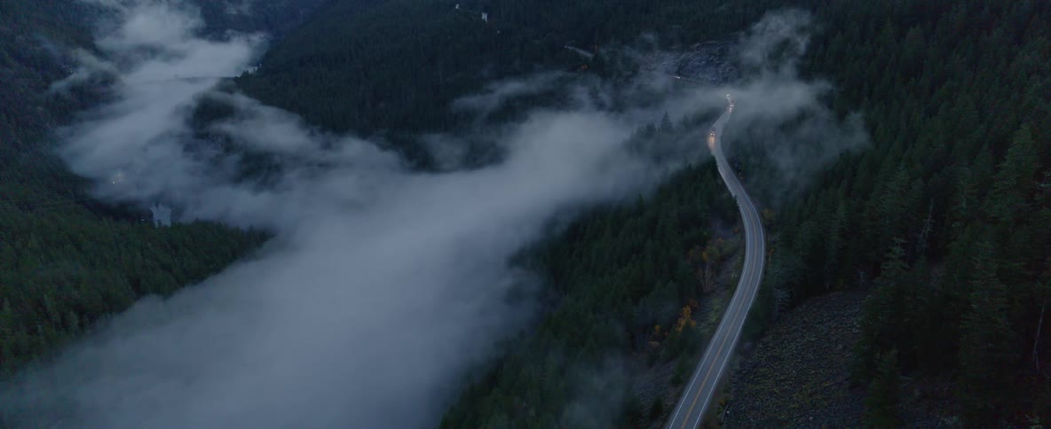 Aerial over a mountain road at night