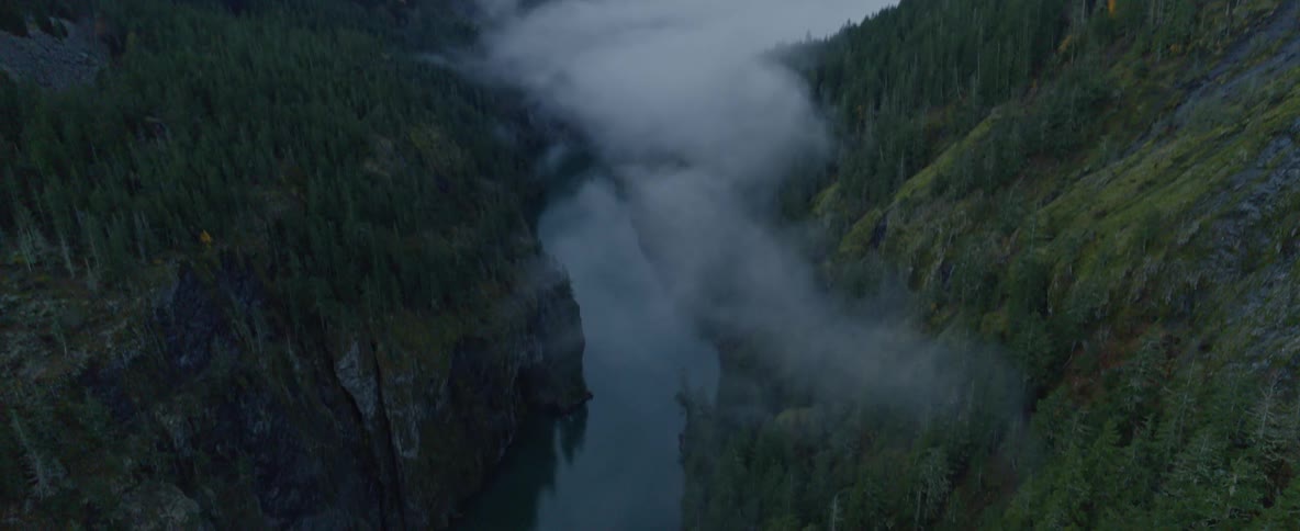 An aerial view of a river and snowy mountains