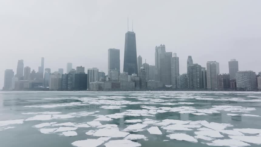 Ice floats on the water with Chicago skyline in the background