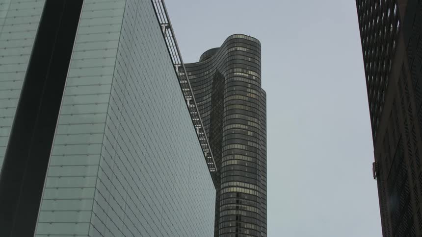 An overcast sky looms over skyscrapers in a city
