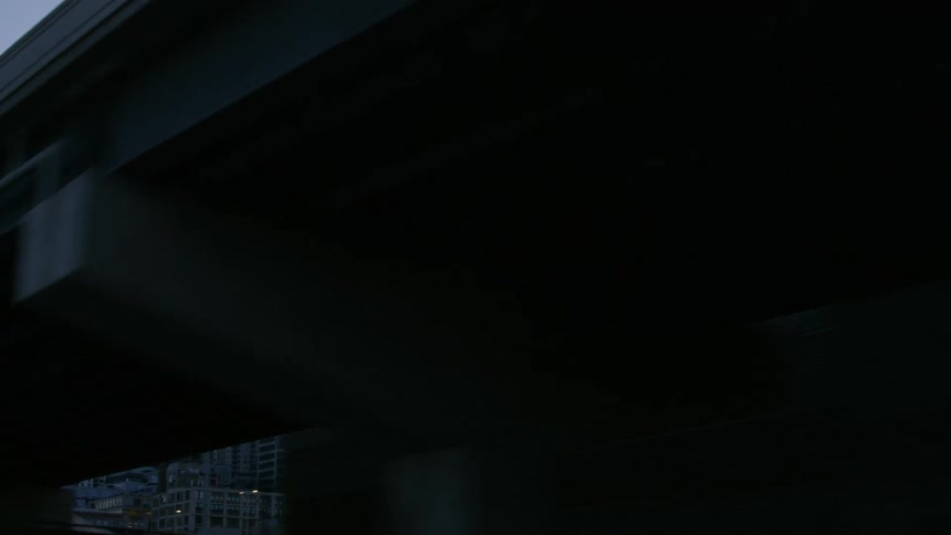 The upper floors of tall skyscrapers are visible over a bridge downtown