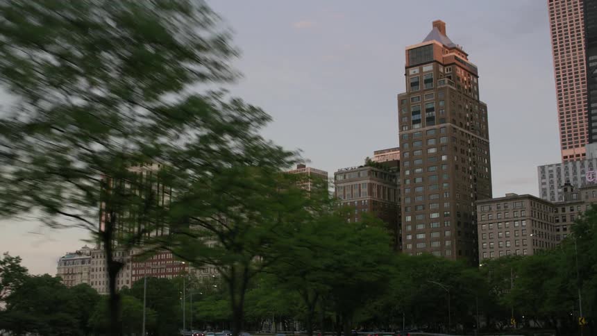 Cars driving past office buildings and hotels in a city