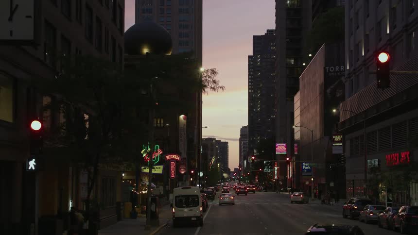 A view of people walking around in chicago at dusk