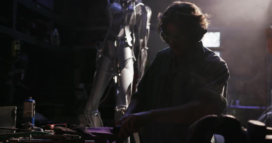 A man is working with his tools in a shop