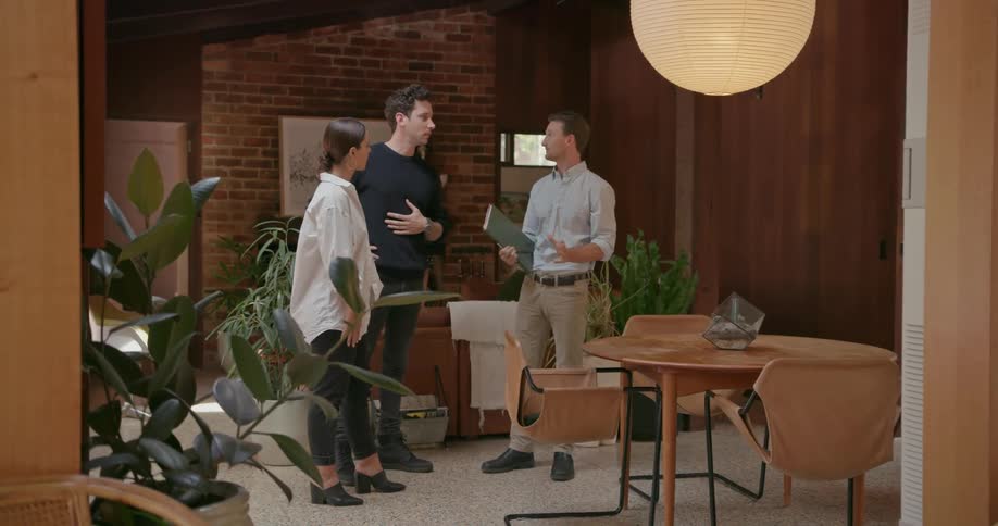 People talk together standing and pointing around a room