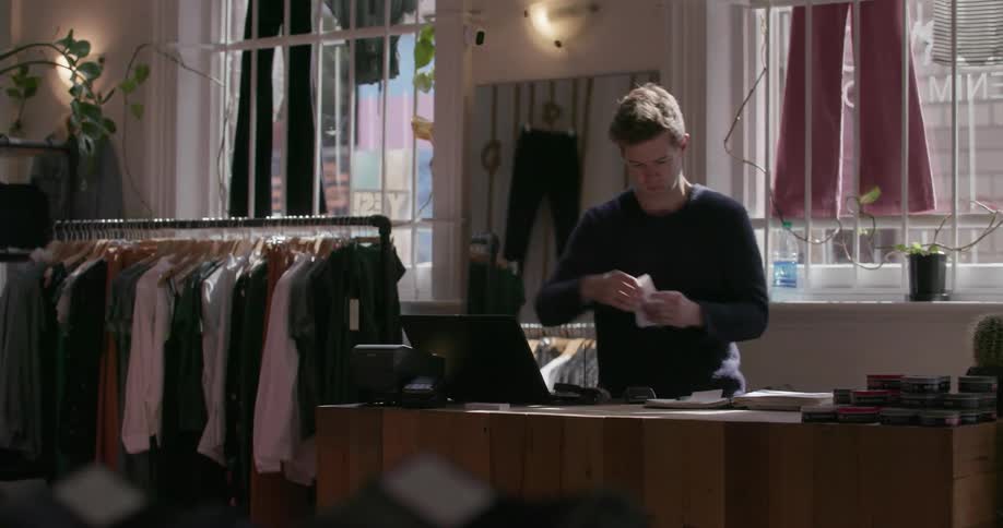 A man prints out a receipt in the shop