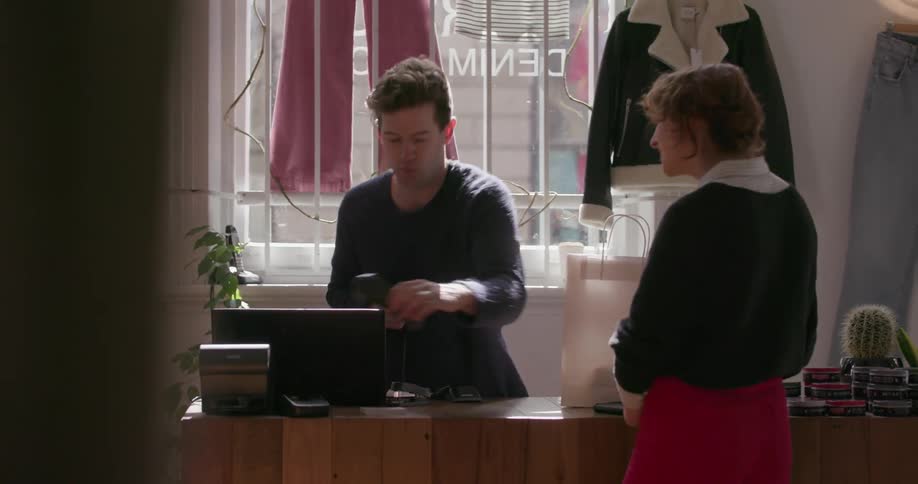 A man accepts a credit card from a customer