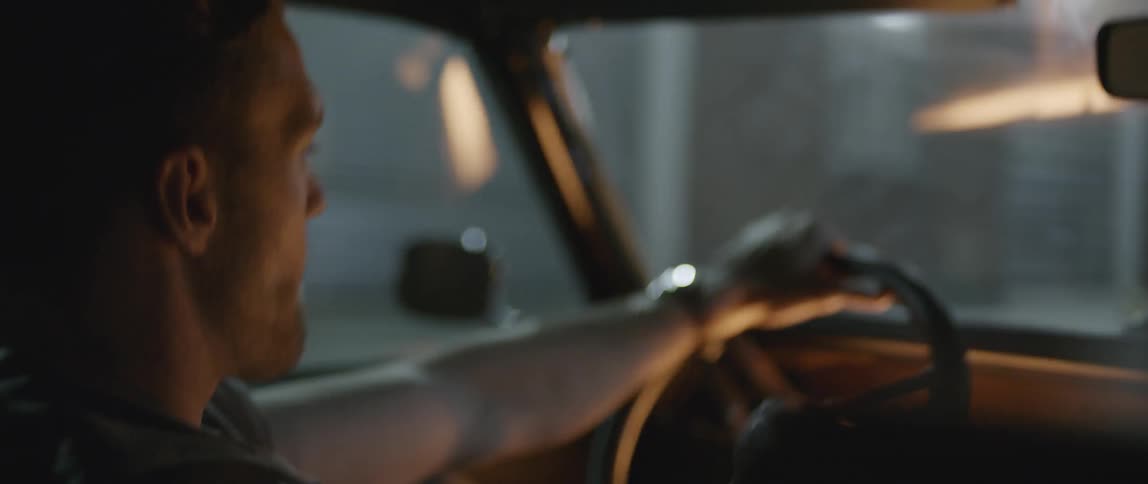 A couple driving through a city at night