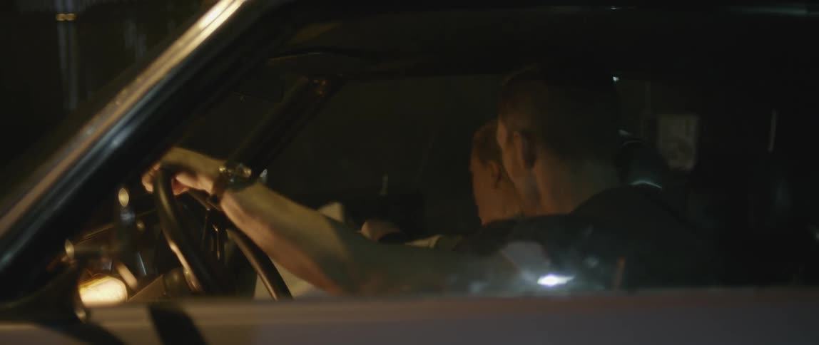 A woman gets into a car with a man at night and they argue