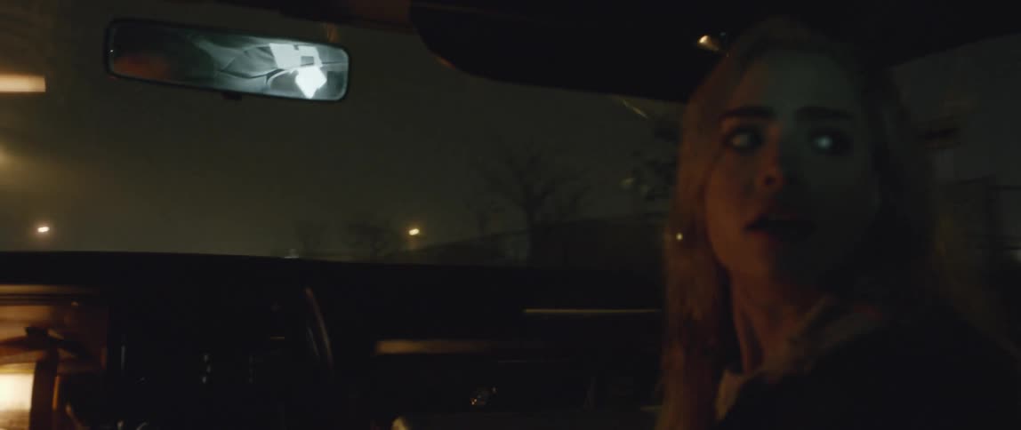 A woman looks back in fear as a man speeds off into the night