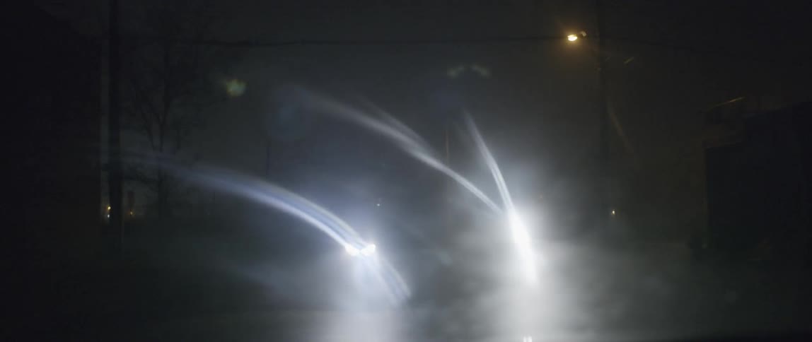 Lights from other cars can be seen through a moving vehicle window at night