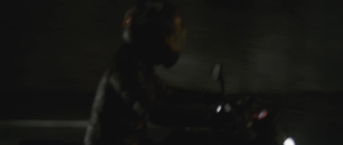 People speed motorcycles on a road at night