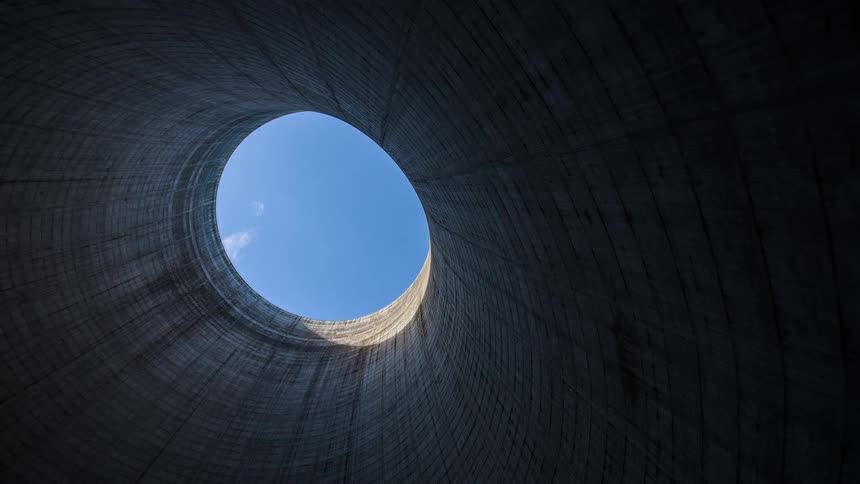 A timelapse shot looking up from inside a nuclear reactor cooling tower clouds moving