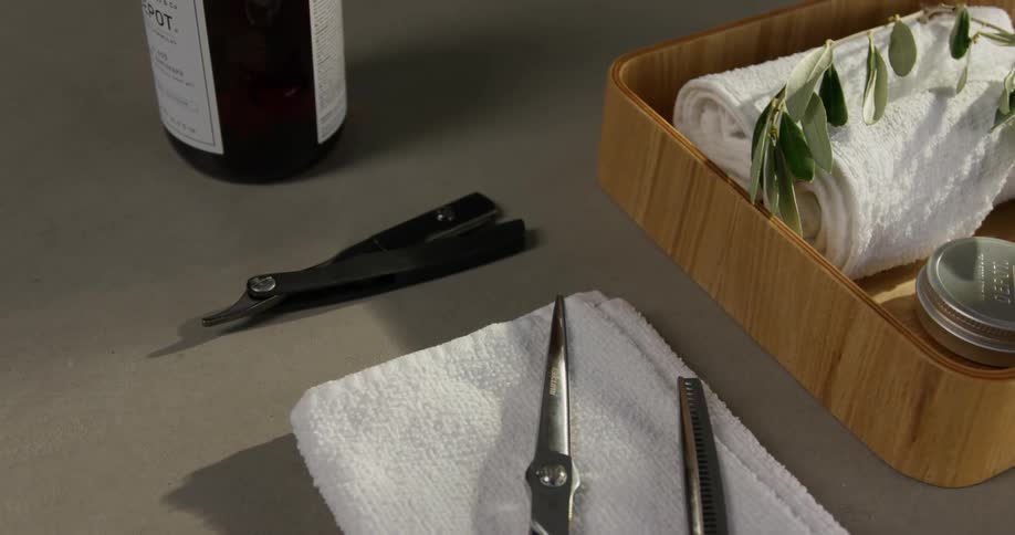 Wine bottle next to wooden tray towel and scissors