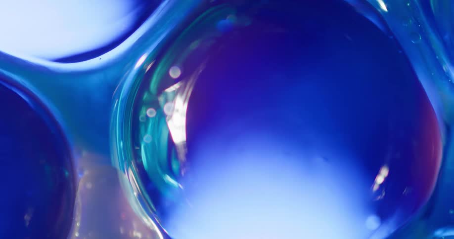 A blue light emerges behind turquoise bubbles