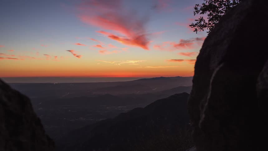 The sun is setting on the mountain range