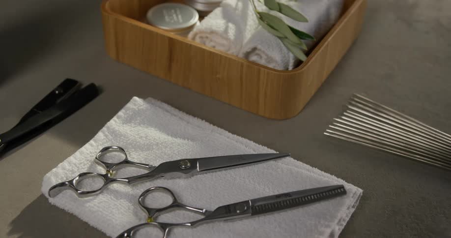 Scissors are laying on a white towel