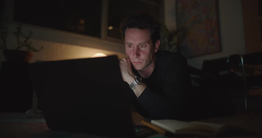 A man is looking at his laptop