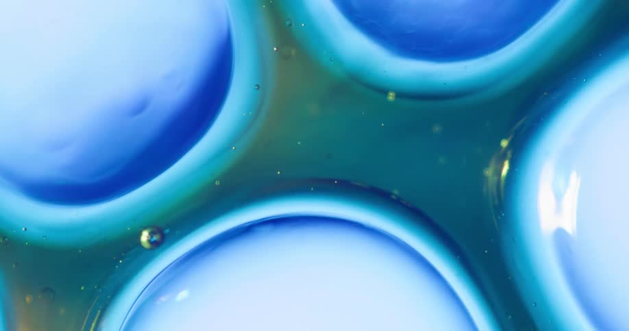 Close up of abstract liquid circles moving around