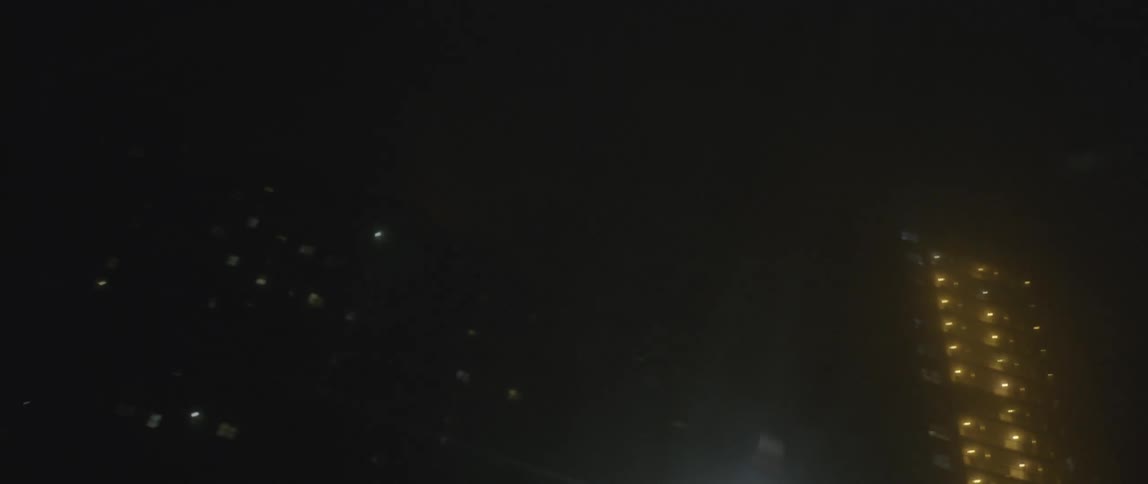 Driving down a brightly lit city at night