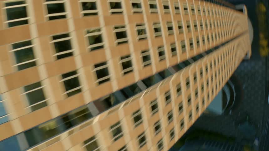 A skyscraper with a pyramid on top stands high over the city among other buildings and towers