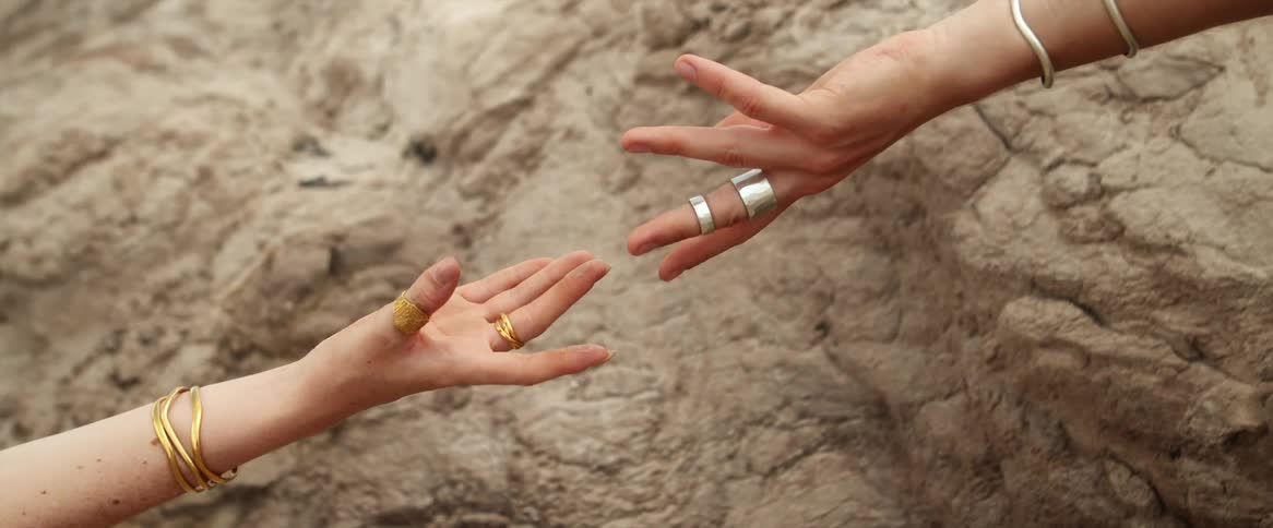 Two people reaching out to each other