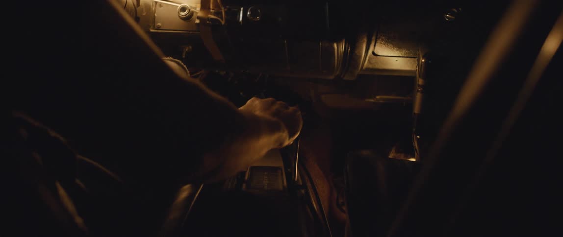 A person puts their car into gear