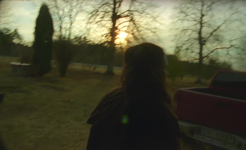 A woman walks out of the shed