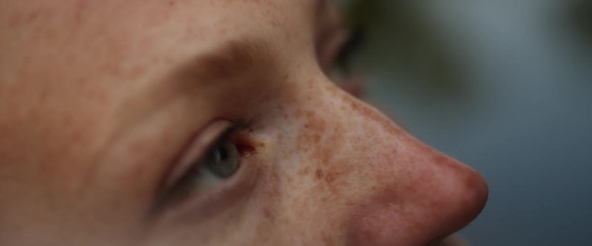 Close up view of a womans face is displayed